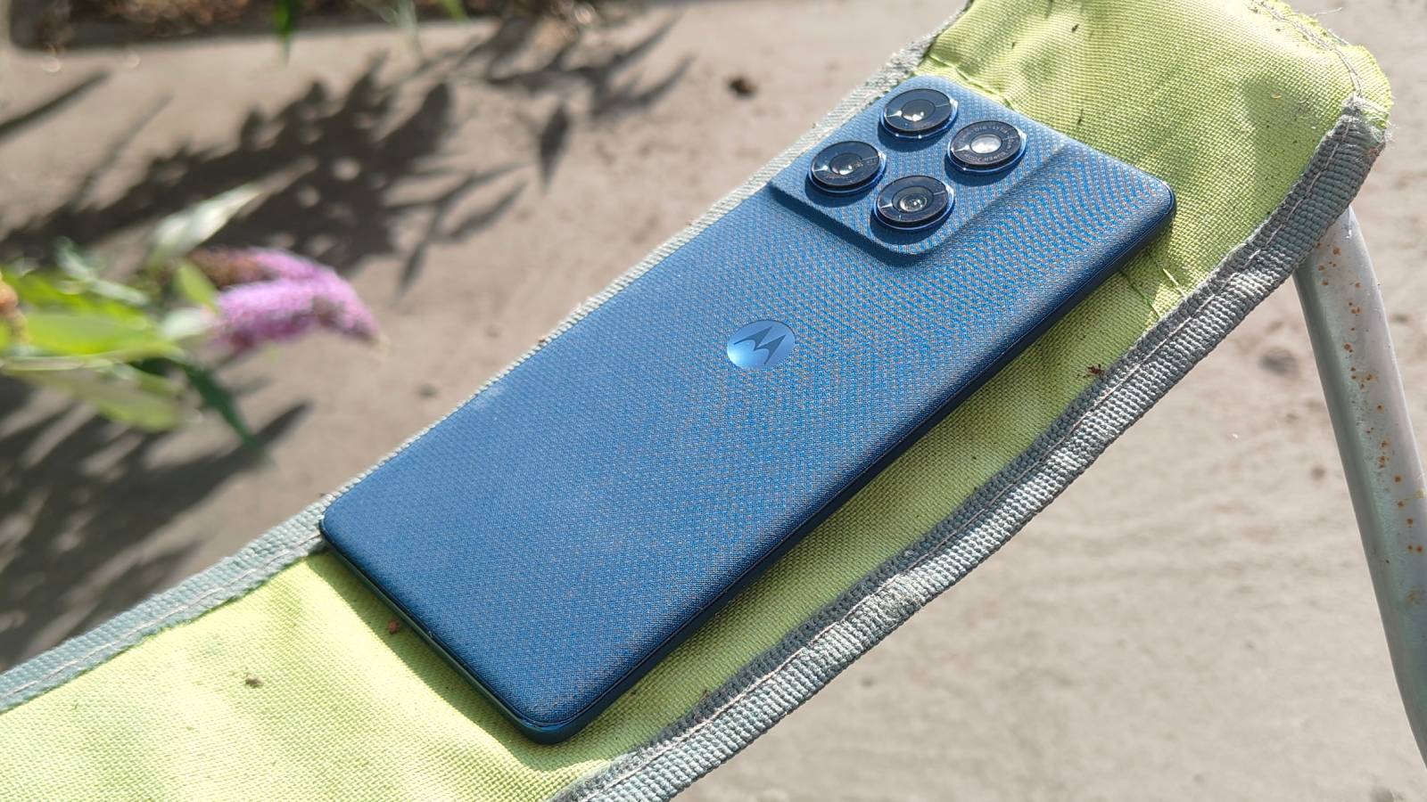 The Motorola Edge 60 on the arm of a chair.