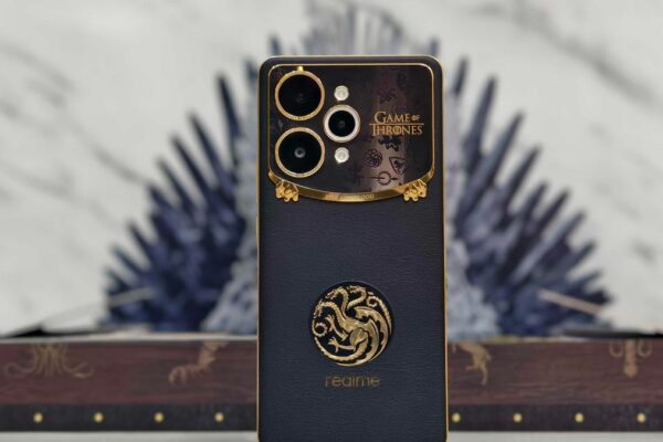 Realme 15 Pro Game of Thrones Limited Edition standing infront of the 3D Iron Throne in-box replica.