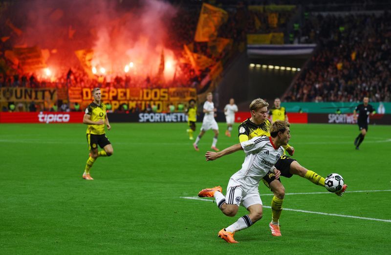 Football: Soccer-Dortmund advance in German Cup after shootout win at Frankfurt