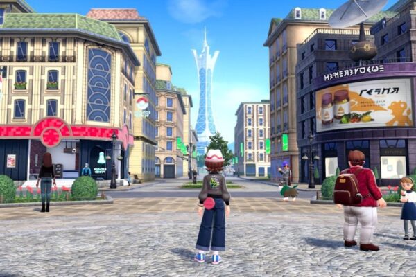 A trainer stands in a City square looking up at a tower in the distance