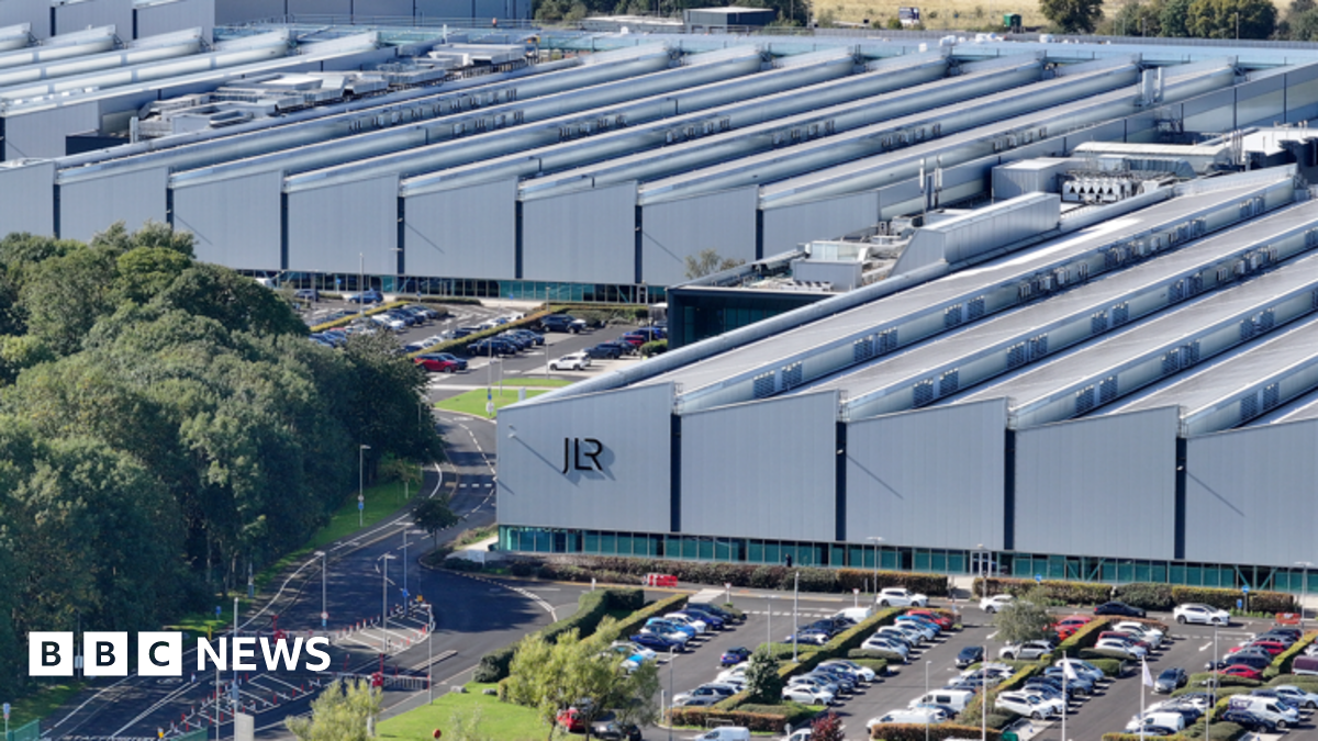 The Janguar Land Rover sign seen outdoors, with the blue sky behind it