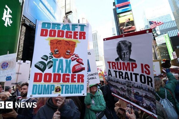 An aerial shot of Times Square shows large crowds of protestors