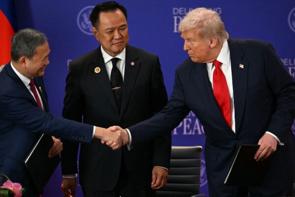 Thailand's Prime Minister Anutin Charnvirakul watches Cambodia's Prime Minister Hun Manet, left, and U.S. President Donald Trump shake hands on the sidelines of the 47th Association of Southeast Asian Nations (ASEAN) summit in Kuala Lumpur, Malaysia, Sunday, Oct. 26, 2025. (Mohd Rasfan/Pool Photo via AP)