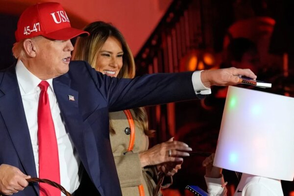 Trump puts candy on trick-or-treater’s head at Halloween event