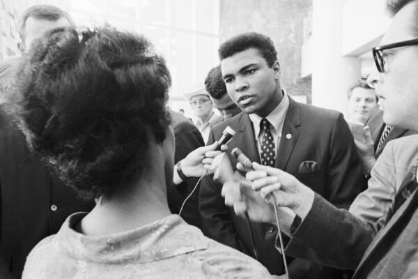 Muhammad Ali speaking with reporters after his 1967 federal indictment for refusing to be inducted into the U.S. armed forces. (Bettmann via Getty Images)