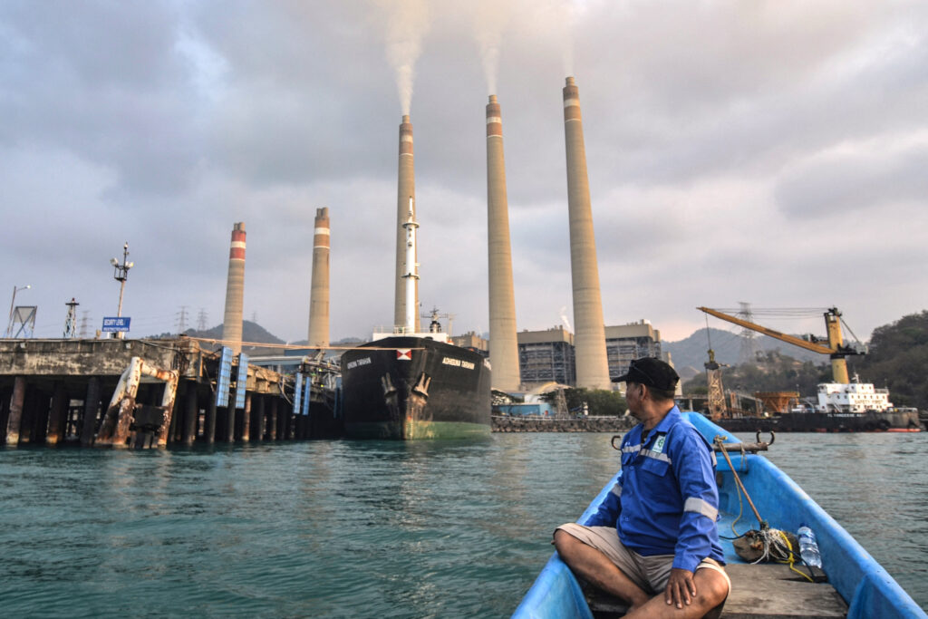 A fisherman observes the coal-fired Suralaya Power Station in Banten Province, Indonesia, on Oct. 31, 2023. Credit: Ronald Siagian/AFP via Getty Images