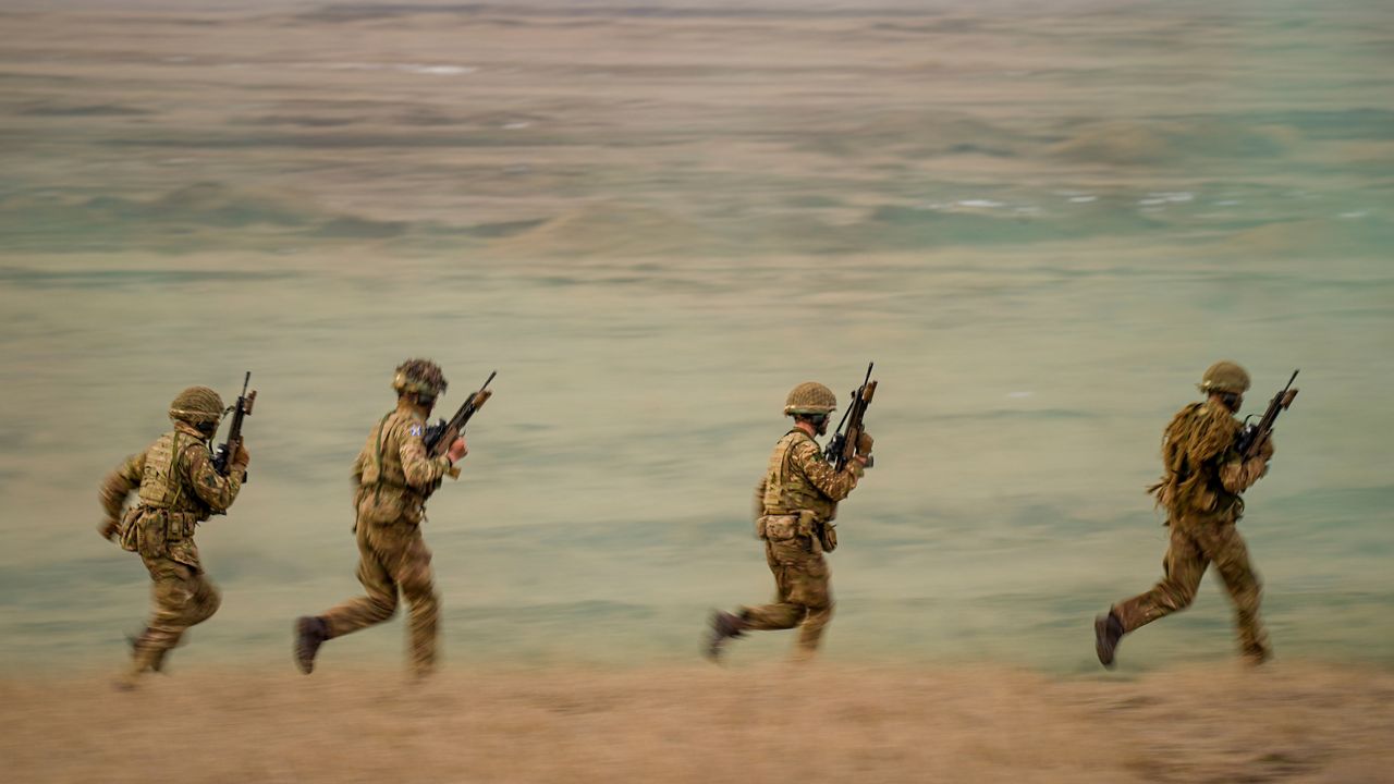 Servicemen run during the Steadfast Dart 2025 exercise, involving some 10,000 troops in three different countries from nine nations, representing the largest NATO operation planned this year, at a training range in Smardan, eastern Romania, Wednesday, Feb. 19, 2025. (AP Photo/Vadim Ghirda, file)