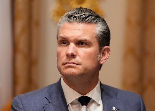 Defense Secretary Pete Hegseth listens as President Donald Trump speaks before a lunch with Ukraine