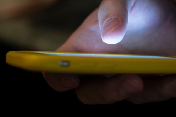 A man uses a cell phone in New Orleans on Aug. 11, 2019.