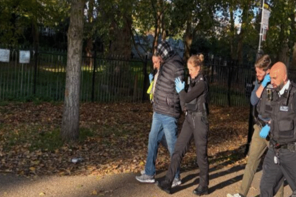 Hadush Kebatu being arrested in Finsbury Park being led away by police officers