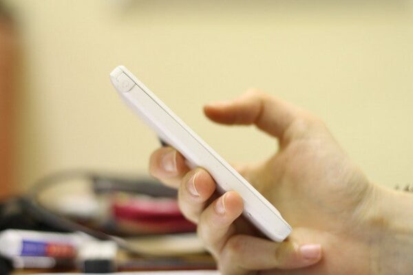 hand typing on cell phone