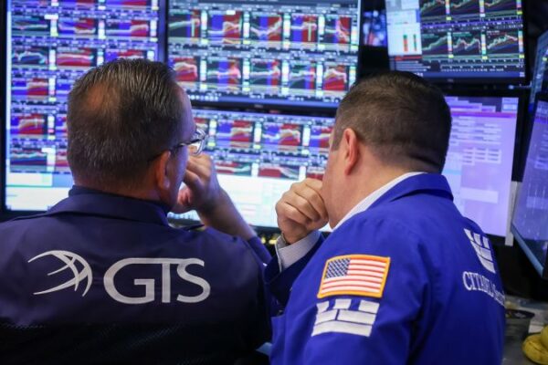 Stocks slide as government officially shuts down