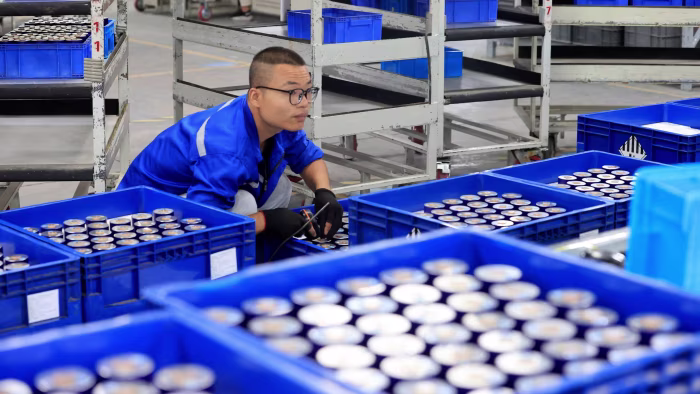 Workers produce new energy vehicle batteries on a production line in China