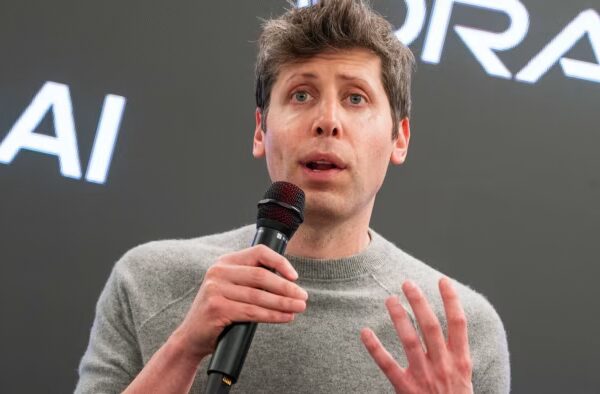 Sam Altman speaks into a microphone during a media tour