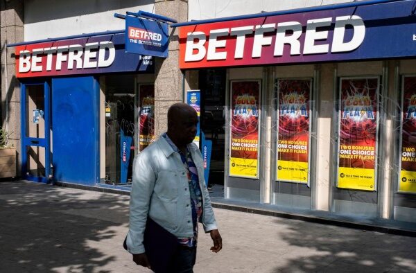 Shopfront of Betfred betting shop with promotional posters in the windows