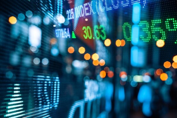 Display of Stock market quotes with city scene reflect on glass