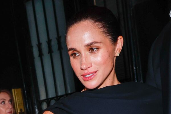 Meghan Markle Wears Asymmetrical Half-Cape Black Gown to Paris Fashion Week