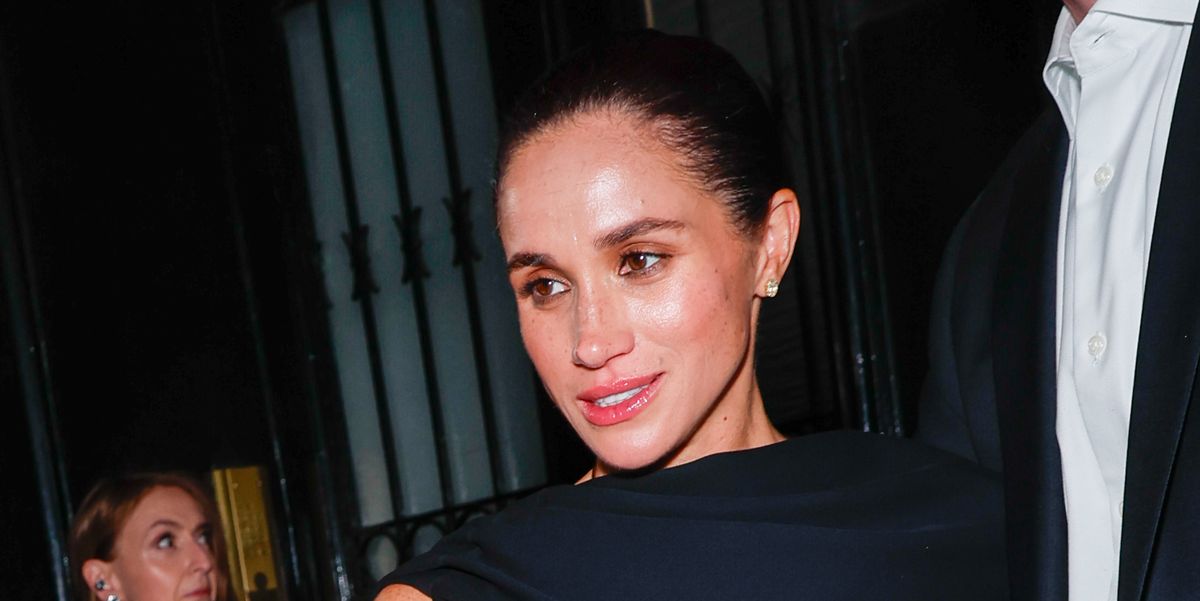 Meghan Markle Wears Asymmetrical Half-Cape Black Gown to Paris Fashion Week