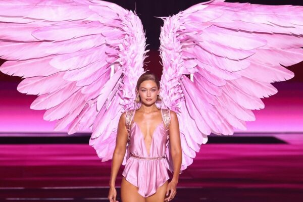 gigi hadid wearing oversized pink angel wings for the victoria's secret fashion show in 2024