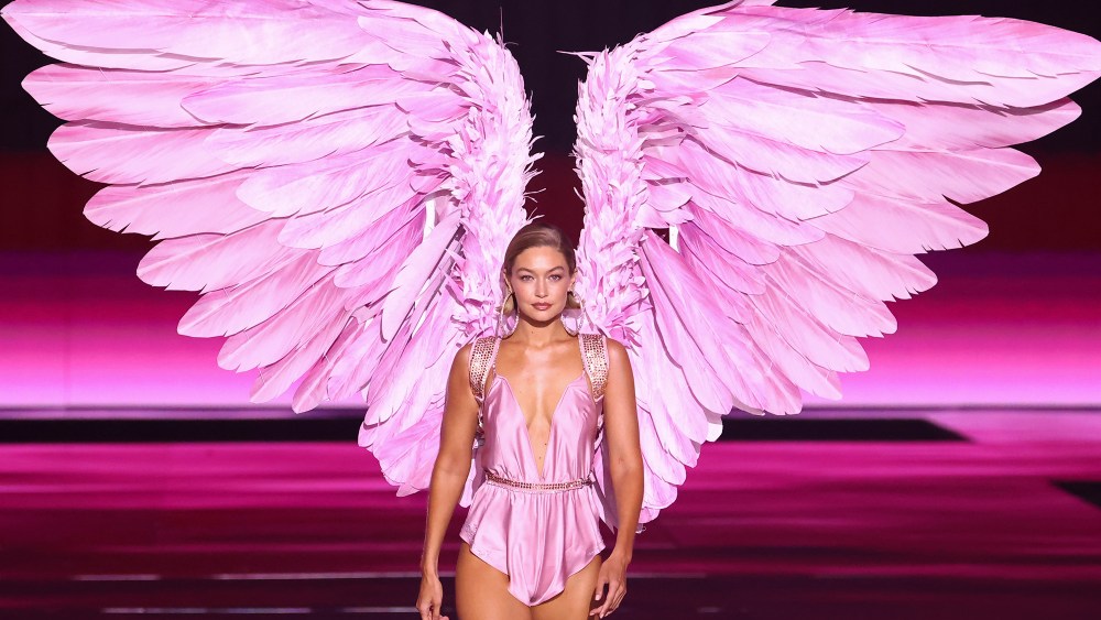 gigi hadid wearing oversized pink angel wings for the victoria's secret fashion show in 2024