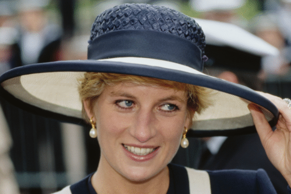 Princess Diana wearing a navy and white hat and matching outfit