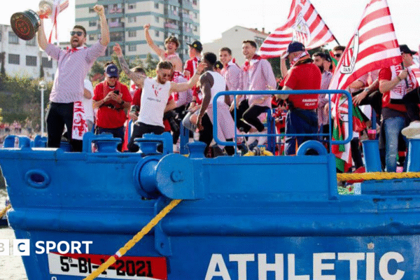 Athletic players celebrate on a barge
