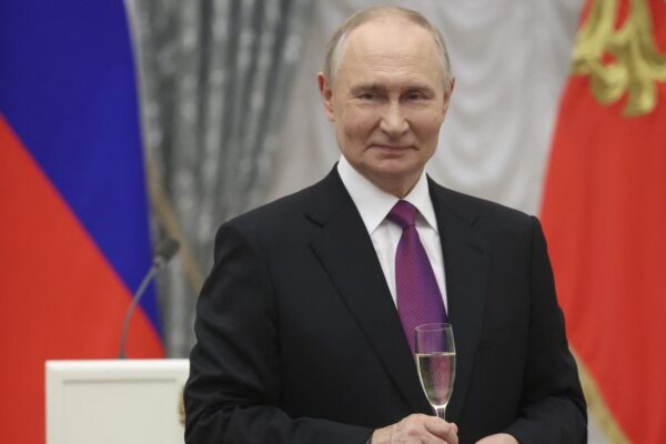 Russian President Vladimir Putin toasts with honourees of Russian awards after an awards ceremony marking the National Unity Day at the Kremlin in Moscow on November 4, 2025. (Photo by MAXIM SHIPENKOV / POOL / AFP)