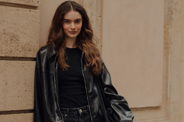 woman wearing a black t-shirt and a black leather jacket.