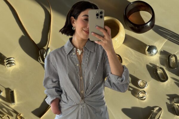 April Lockhart wearing her inclusive jewelry in front of a plain backdrop