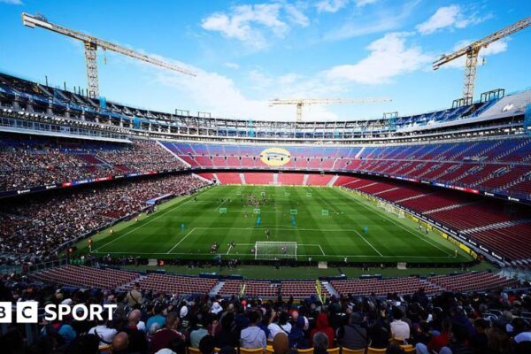 General view of the stadium with Barcelona players during an open training session at the Nou Camp