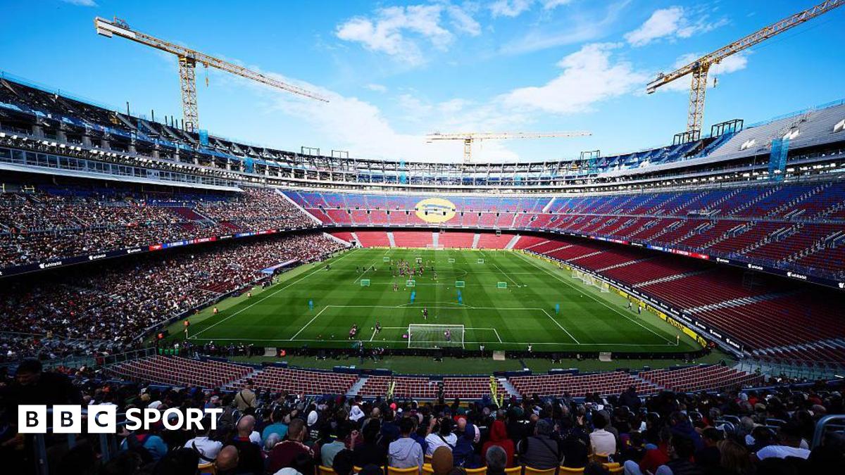 General view of the stadium with Barcelona players during an open training session at the Nou Camp