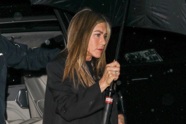 Jennifer Aniston wears cuffed blue jeans and white sneakers for date night with her new boyfriend