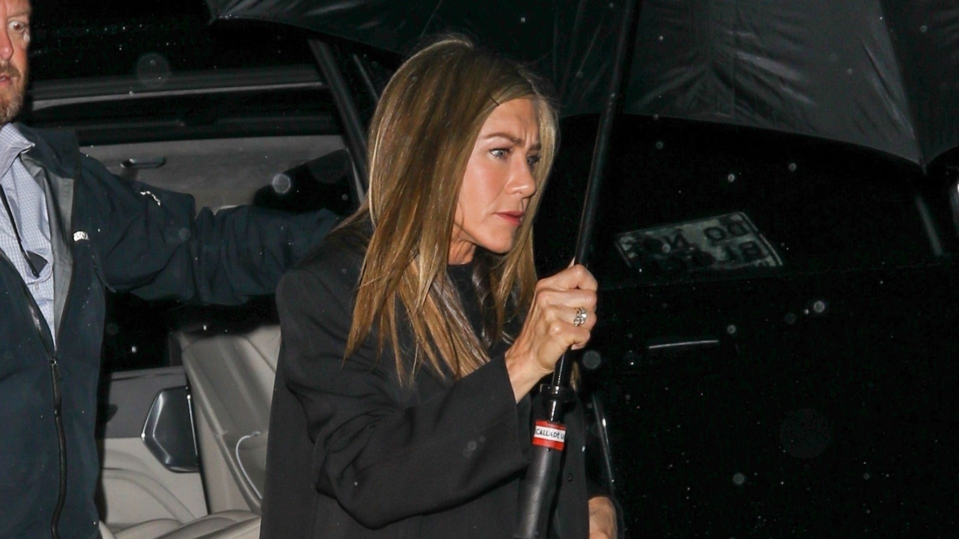 Jennifer Aniston wears cuffed blue jeans and white sneakers for date night with her new boyfriend