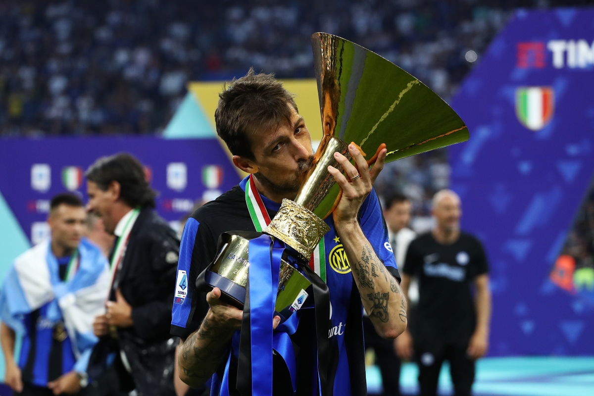 MILAN, ITALY - MAY 19: Francesco Acerbi of FC Inter kisses the Serie A TIM Scudetto title trophy at full-time following the team