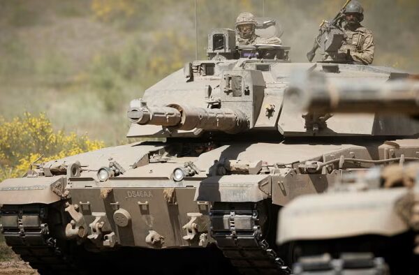 Two Challenger 2 tanks from the 2nd Royal Tank Regiment with soldiers visible in the hatches during a Nato exercise.