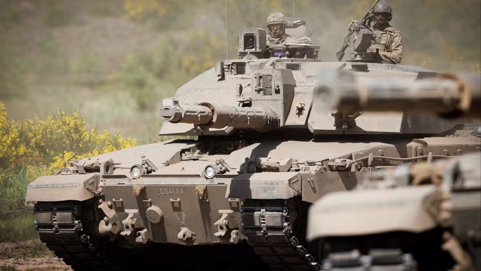 Two Challenger 2 tanks from the 2nd Royal Tank Regiment with soldiers visible in the hatches during a Nato exercise.