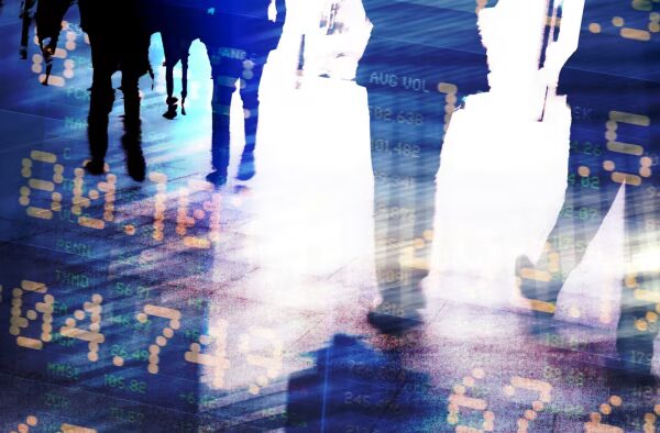 Blurred silhouettes of people walking overlaid with digital financial data, numbers, and stock market indicators