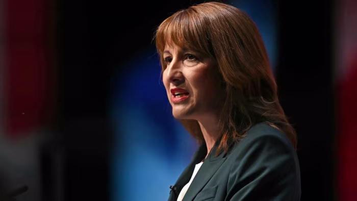 Rachel Reeves speaks at a podium, appearing serious, during the Labour party conference.