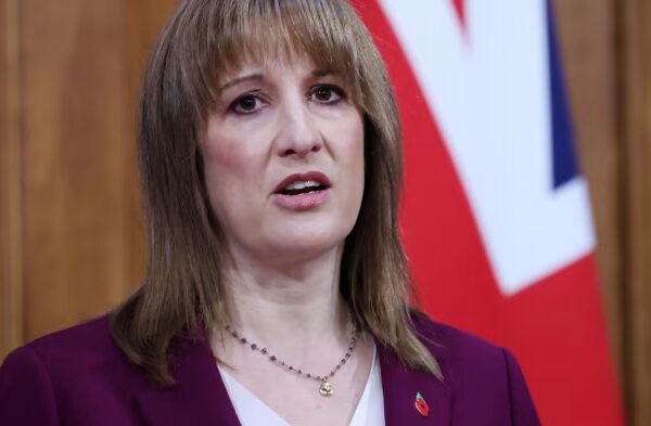 Rachel Reeves speaks during a pre-budget address, with part of a UK flag visible in the background