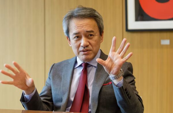 Masayuki Omoto gestures with both hands while speaking during an interview at Marubeni’s headquarters.