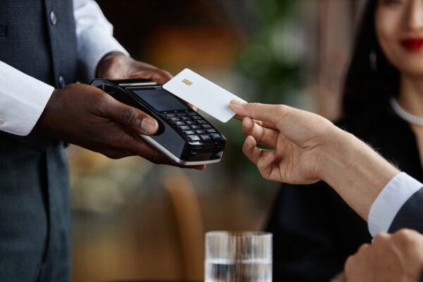 Person paying at restaurant with card.