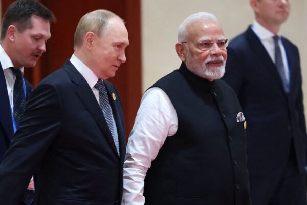 TOPSHOT - In this pool photograph distributed by the Russian state agency Sputnik, Russia's President Vladimir Putin (L) speaks with Indian Prime Minister Narendra Modi during the Shanghai Cooperation Organisation (SCO) Summit in Tianjin on September 1, 2025. (Photo by Alexander KAZAKOV / POOL / AFP)