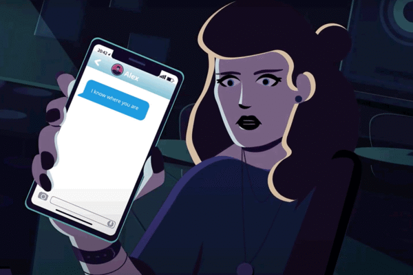 woman holding phone with stalker message