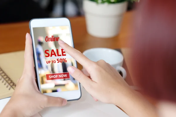 A person clicking on a Black Friday online sale on a smartphone.