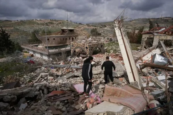 People walk at a damaged site in Mays al-Jabal, near the border with Israel, southern Lebanon, February 19, 2025 (credit: REUTERS/Mohammed Yassin)
