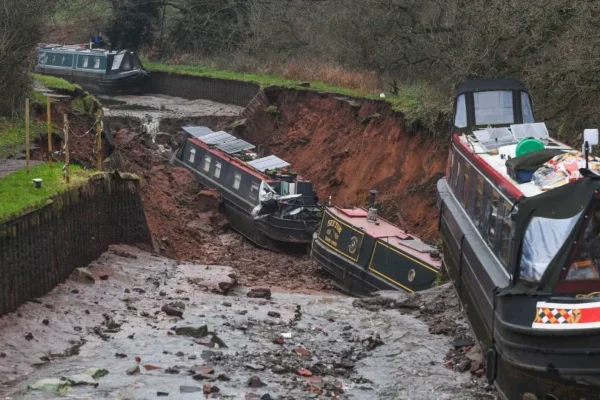 Canal boats lie damaged after a sinkhole developed in Shropshire, England, on December 22, 2025. - Andy Kelvin/PA via AP