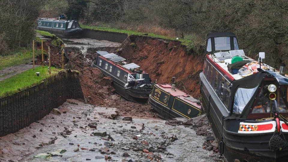 Canal boats lie damaged after a sinkhole developed in Shropshire, England, on December 22, 2025. - Andy Kelvin/PA via AP