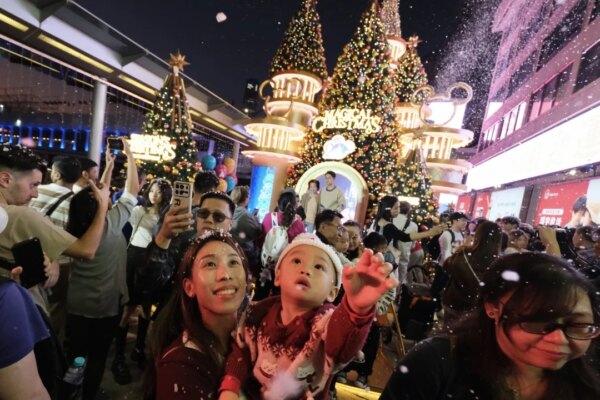 Christmas Eve crowds gather in Hong Kong but festive atmosphere ‘more subdued’