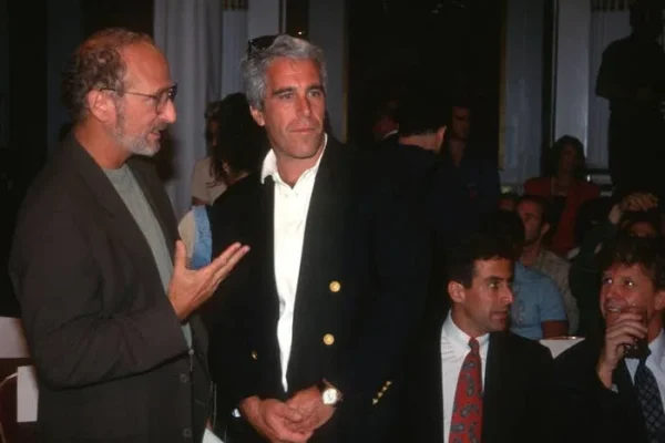 Guest and Jeffrey Epstein attend the Victoria's Secret Fashion Show at the Plaza Hotel on August 1, 1995