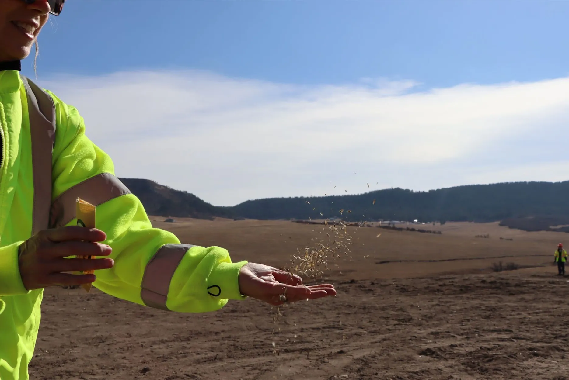 A worker scatters seeds.
